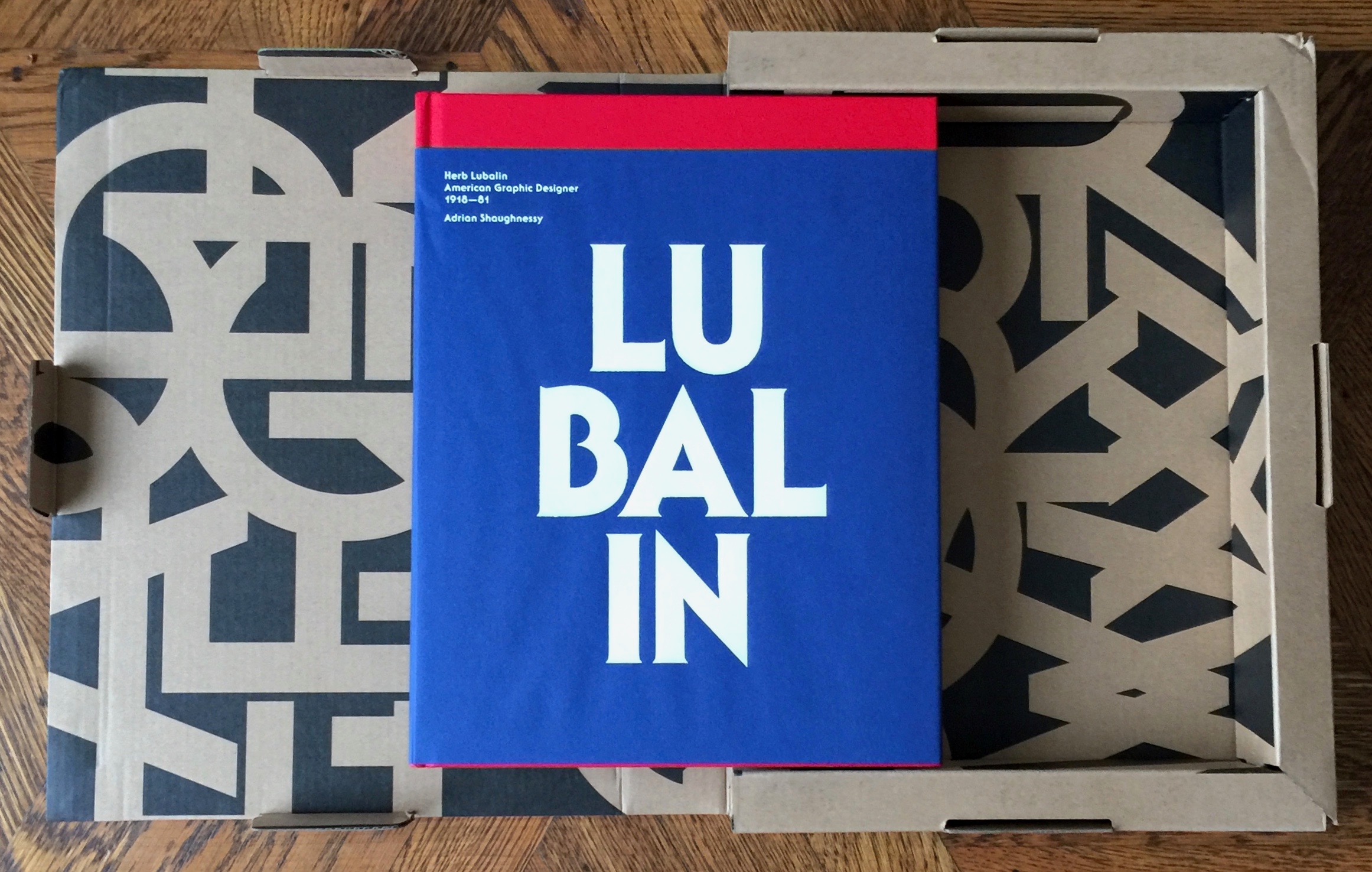 The book Lubalin 100 sitting on its open card board case.