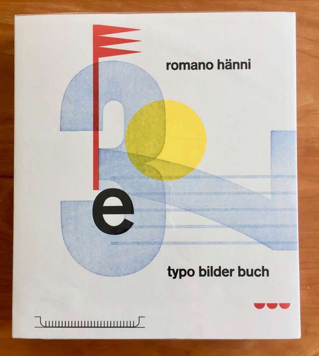 The cover of Typo Bilder Buch, with abstract shapes and light washed out numbers 3 and 7