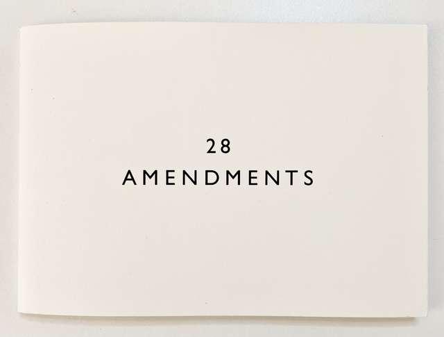 A landscape book, it is plain with a simple cover displaying the title 28 Amendments
