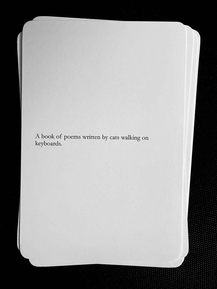A card saying: A book of poems written by cats walking on keyboards.
